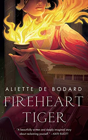 Book cover for FIREHEART TIGER: title in white below a woman in billowing clothes holding a bowl of flamesa